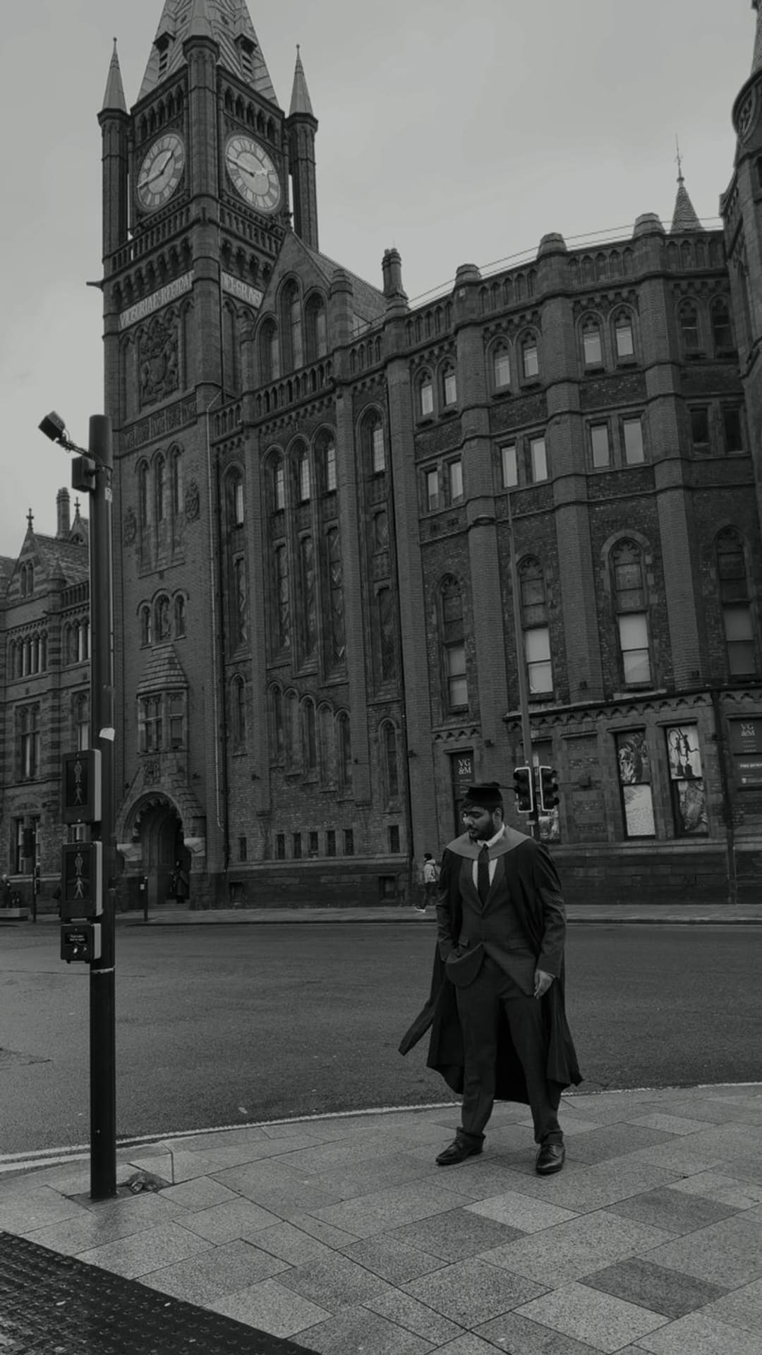 Omkar in cap and gown outside the Victoria Building, University of Liverpool