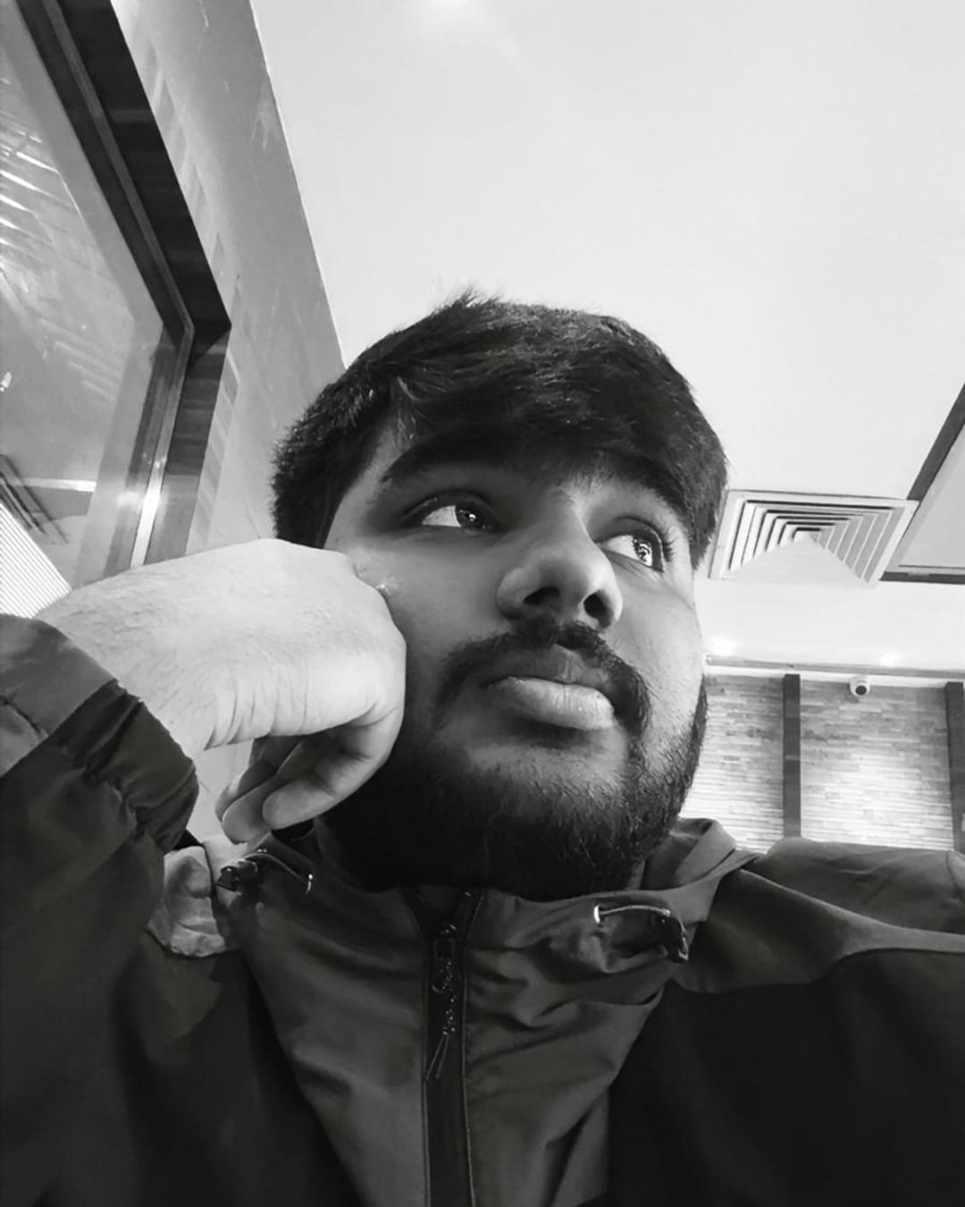 Omkar Mhatre, close up, in a black jacket
